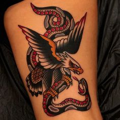 an eagle and snake tattoo on the leg