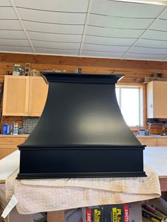 a black stove top sitting in the middle of a kitchen