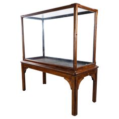 an old wooden display case with glass shelves on the top and bottom, against a white background