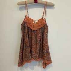 Nwt Anthropologie Camisole In A Coral, Grey And Cream Floral Pattern. Has A Uneven Fringe Hemline, Adjustable Spaghettis Straps And Beautiful Lace Detailing Around Neckline Sleeveless Beach Camisole With Built-in Bra, Bohemian V-neck Camisole For Beach, Summer Camisole With Built-in Bra, Vacation Tank Top With Adjustable Spaghetti Straps, Vacation Spaghetti Straps Tank Top With Adjustable Straps, Summer Sleeveless Tops With Adjustable Straps, Beach Camisole With Straps, Summer Tops With Adjustable Straps And Sleeveless Design, Bohemian Beach Tops With Built-in Bra