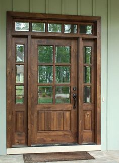 a wooden door with glass on the outside