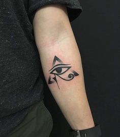 an all seeing eye tattoo on the left arm is shown in black and grey colors