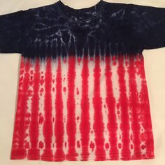 Tie dye Large kids crew neck Tshirt.  The shirt pictured is the one you will receive.  It is a Faded Glory brand crew neck Large children's or pre- teen shirt size 14-16. Made with a deep royal blue and red for the colors of our American flag.  It was tied so that you get the shots of white throughout the blue.   Faded Glory can run a bit smaller then some of the other manufacturers so check out the measurements.  It is a very good quality 100% cotton knit shirt.  It measures 21 1/2 inches from the tip of the crew neck at the shoulder to the hem and 17 inches across or 34 inches around. If you would like this in another size, leave me a message and I can private message you a picture of the one you will get before you buy it.  It will look very much like the one pictured here. Smaller chil Red Tops With American Flag For Independence Day, Multicolor Crew Neck Top For 4th Of July, Multicolor American Flag Tops For Summer, Red American Flag Top For Independence Day, Patriotic Red Top With American Flag, Red American Style Tops For Memorial Day, American Style Red Tops For Memorial Day, Multicolor American Flag Print Top For Memorial Day, Multicolor Flag Print Top For Memorial Day