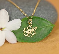 Hibiscus flower necklace - Hawaiian necklace - beach necklace - tropical necklace - tiny charm necklace This super cute gold vermeil hibiscus flower hangs happily from a 14k gold vermeil chain in the length of your choice. The are other fun charms available! Jellyfish - 8mmx12mm Cactus+Sun - 11mm Hibiscus - 9mm Cactus - 9mmx13mm Palm tree - 11mm Looking for other charm necklaces? https://www.etsy.com/shop/BubuRuby?section_id=12318467 More from Bubu Ruby? https://www.etsy.com/shop/BubuRuby?ref=si Gold Beach Jewelry With Flower Charm, Gold Jewelry With Flower Charm For Beach, Gold Flower Jewelry For Beach, Dainty Flower Pendant Charm Necklace, Dainty Nickel Free Flower Pendant Charm Necklace, Dainty Nickel-free Flower Pendant Charm Necklace, Beach Flower Pendant Necklace, Tropical Necklace, Hawaiian Necklace