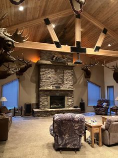 a living room with deer heads mounted to the ceiling