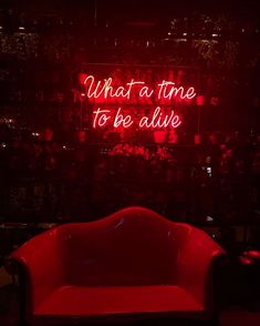 a red neon sign that says what time to be alive on the side of a wall