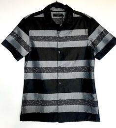 AllSaints Gabon Short Sleeve Shirt. Color on the tag says Black. It has a wide black stripe alternating with a grey stripe and a black with White stitch markings in. Polyester cotton blend that can be machine washed. Size XS AllSaints is a top London fashion designer, patronized by many famous music artists and celebrities. Measurements taken lying flat. Shoulder to waist hem 28.5 inches long. Armhole seam across front of chest to opposite armhole seam 21.5 inches Retails for $155 see photo of a Casual Black Tops With Striped Sleeves, Black Fitted Top With Contrast Stripes, Casual Black Top With Striped Sleeves, Fitted Black Top With Contrast Stripes, Casual Black Tops With Vertical Stripes, Allsaints Fitted Tops For Spring, Black Vertical Stripes Top For Spring, Modern Fitted Tops With Striped Collar, Black Vertical Striped Top For Spring