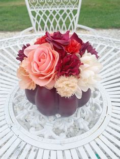 a vase filled with flowers sitting on top of a white table