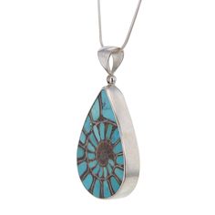 this elegantly simple yet extravagant Jurassic era Ammonite pear shaped pendant with Turquoise inlays is truly awe inspiring and beautiful hand crafted in .925 Sterling Silver it to enhance the stunning center piece the pendant entrances with its geometric progressions and is often called the Fibonaci fossil Ammonite shells are a naturally occurring example of the Fibonacci sequence. If one draws a quarter circle in each Fibonacci square, they connect to form an ever increasing spiral metaphysic Turquoise Teardrop Pendant Jewelry, Turquoise Teardrop Cabochon Necklace, Unique Turquoise Teardrop Pendant Jewelry, Sterling Silver Teardrop Turquoise Necklace, Artisan Teardrop Inlay Jewelry, Unique Teardrop Pendant Turquoise Necklace, Unique Sterling Silver Turquoise Teardrop Necklace, Unique Teardrop Turquoise Necklace With Natural Stones, Unique Teardrop Turquoise Necklace With Large Pendant