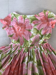 "This lovely sundress is all sweetness and sunshine. Pinks and greens are such a great combination! I loveeeee the pink mother of pearl buttons! Bust 36\" Waist 26\" Length 38\" This item is clean and ready to wear. Comes from a smoke and pet free home. Don't forget to follow me on Instagram @tammaraclearshercloset for new listing alerts. This is shipping from Singapore. Standard post takes about 10 working days. Please contact me if you need it urgently. H151" Pink Tea Length Summer Dress, Pink Tea-length Summer Dress, Summer Garden Party Dress With Box Pleat, 1950s A-line Vintage Summer Dress, Summer Dresses With Box Pleat And Full Skirt, Pink Fitted Dress With Box Pleat, Spring Tea-length Dress With Box Pleat, 1950s Style Short Sleeve Summer Dress, 1950s Style Pink Tea-length Dress