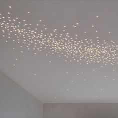 the ceiling is covered with white lights in an empty room