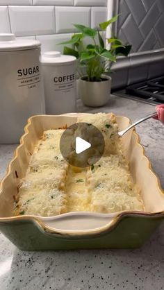 a casserole dish filled with cheese and sauce being spooned into the casserole