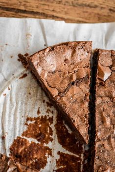 two pieces of brownie sitting on top of a piece of paper