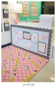 a pink and yellow area rug on the floor in front of a wall with pictures