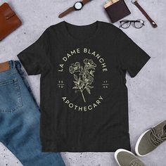 Trendy Fashion La Dame Blanche Apothecary T-Shirt | Sassenach Shirt | Outlander Tee , Women's Tops Outlander Tshirt, Outlander T Shirts, Claire And Jamie, Outlander Gifts, Rose Apothecary, Scripture Shirt, Bible Verse Shirt, Claire Fraser, Outlander Fan