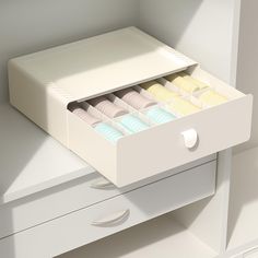 an open drawer in a white cabinet filled with macaroni and cheeses,