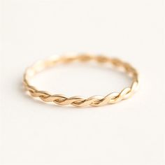 This beautiful Thin Braid Ring is 14k gold filled and perfect for stacking with other rings or wearing on its own. The delicate braid design is eye-catching and unique, and the intertwined detail makes it even more special, representing the intertwining of two lives. Whether you're looking for a solo and simple everyday ring or to create your own stacking style, the Thin Braid Ring is a great choice. Gold Filled Thin Braid Ring Details: Hypoallergenic, Tarnish-Free, Sweatproof & Waterproof Metal Layer Rings, Tuscan Summer, Flower Cuff Bracelet, Dainty Initial Necklace, Rings Ideas, Dot Ring, Future Self, Past And Future, Everyday Ring