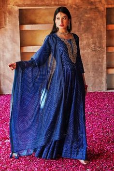 Navy blue long anarkali in chanderi base with bandhani patterns and gota work on yoke. Comes with cotton pant and chanderi dupatta.
Component: 3
Type Of Work: Bandhani Pattern
Neckline: U-Neck
Sleeve Type: Three Quarter
Fabric: Anarkali and Dupatta: Chanderi, Pant: Cotton
Color: Blue
Other Details: 
Gota detailed yoke in floral pattern
Tassel edged dupatta
Occasion: Sangeet - Aza Fashions Designer Blue Anarkali Set With Gota Work, Blue Chanderi Floor-length Palazzo Set, Blue Festive Anarkali Set With Traditional Drape, Blue Anarkali Set For Festive Occasions, Festive Blue Anarkali Set With Traditional Drape, Blue Kurta For Reception And Navratri, Blue Kurta For Reception During Navratri, Blue Anarkali Set With Zari Work For Transitional Season, Transitional Blue Anarkali Set With Zari Work