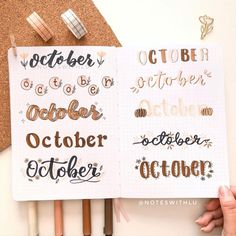 two notebooks with the words october and october written in gold foil on them next to some pencils