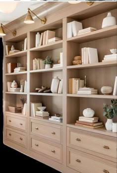 the bookshelves are filled with many different types of books and vases on them