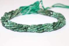 a strand of green beads on a white surface