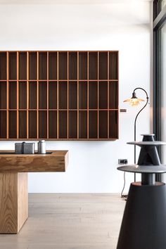 an empty room with wooden shelves and lamps