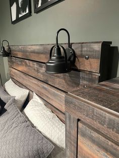 a bed with a wooden headboard and two pictures on the wall next to it