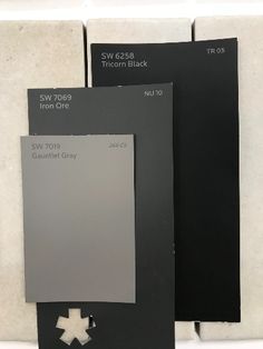 three different shades of black and white paint on the same color palette, each with an individual's own logo