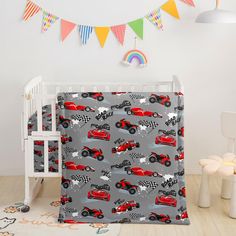 a crib bedding set with cars on it