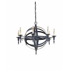 an iron chandelier with six candles hanging from the center and four arms on each end