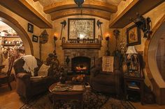 a living room filled with furniture and a fire place in the middle of an archway