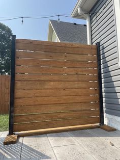 a large wooden fence in front of a house