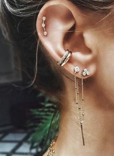 a woman's ear with two different types of piercings