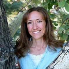 a woman standing in front of a tree