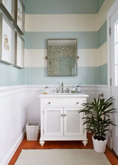 a bathroom with blue and white striped walls