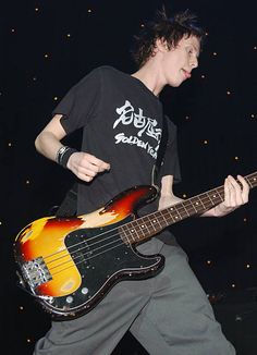 a young man is playing an electric guitar