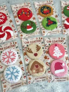 several christmas themed buttons are shown on a table