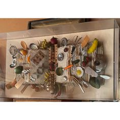 a display case filled with lots of different types of utensils and spoons