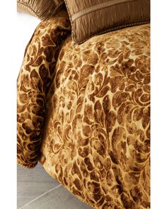 the comforter is made up with brown and tan animal print sheets, along with matching pillows