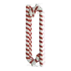 two candy canes are wrapped in red and white yarn