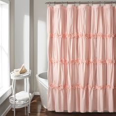 a pink shower curtain in a white bathroom