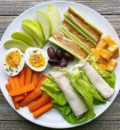 a white plate topped with fruits and vegetables