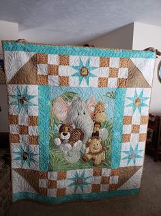 an elephant and mouse quilt on display in a room with the caption'i used my 8 inch block for blocks around the panel and this binding