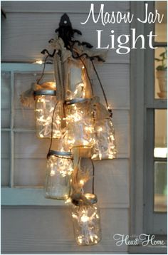 mason jar lights hanging from the side of a house