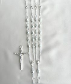 a rosary and a cross on a white background