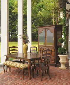 a dining room table and chairs on a brick patio