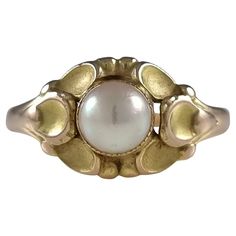 A 14 carat yellow gold and pearl ring, #272, by Georg Jensen. The ring is stamped with the 'GJ' Georg jensen marks used between 1933-44, '585' to denote 14 carat gold, and '272'. Period: - Mid 20th Century. Date: - Circa 1933-44. Maker: - Georg Jensen. Measurement: - UK ring size M (leading edge). US ring size 6 1/4 (leading edge). The ring measures 10.0mm (width) to the front, and 1.5mm to the back Weight: - 3.4 grams. Condition: - Light surface scratches and wear commensurate with age. Please note the pearl is untested and unwarranted for origin. Please see photos for confirmation of condition. Item No: - 2157_br1. Georg Jensen Ring, Gold Pearl Ring, Mid Century Jewelry, Georg Jensen, Gold Pearl, Pearl Ring, Fashion Rings, 20th Century, Jewelry Rings