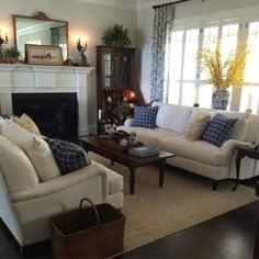 a living room with two couches and a coffee table in front of a fireplace