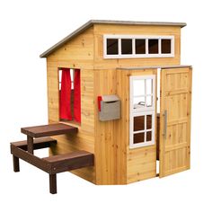 a wooden play house with a picnic table