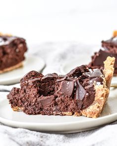 there is a piece of chocolate pie on the plate and one slice has been taken out